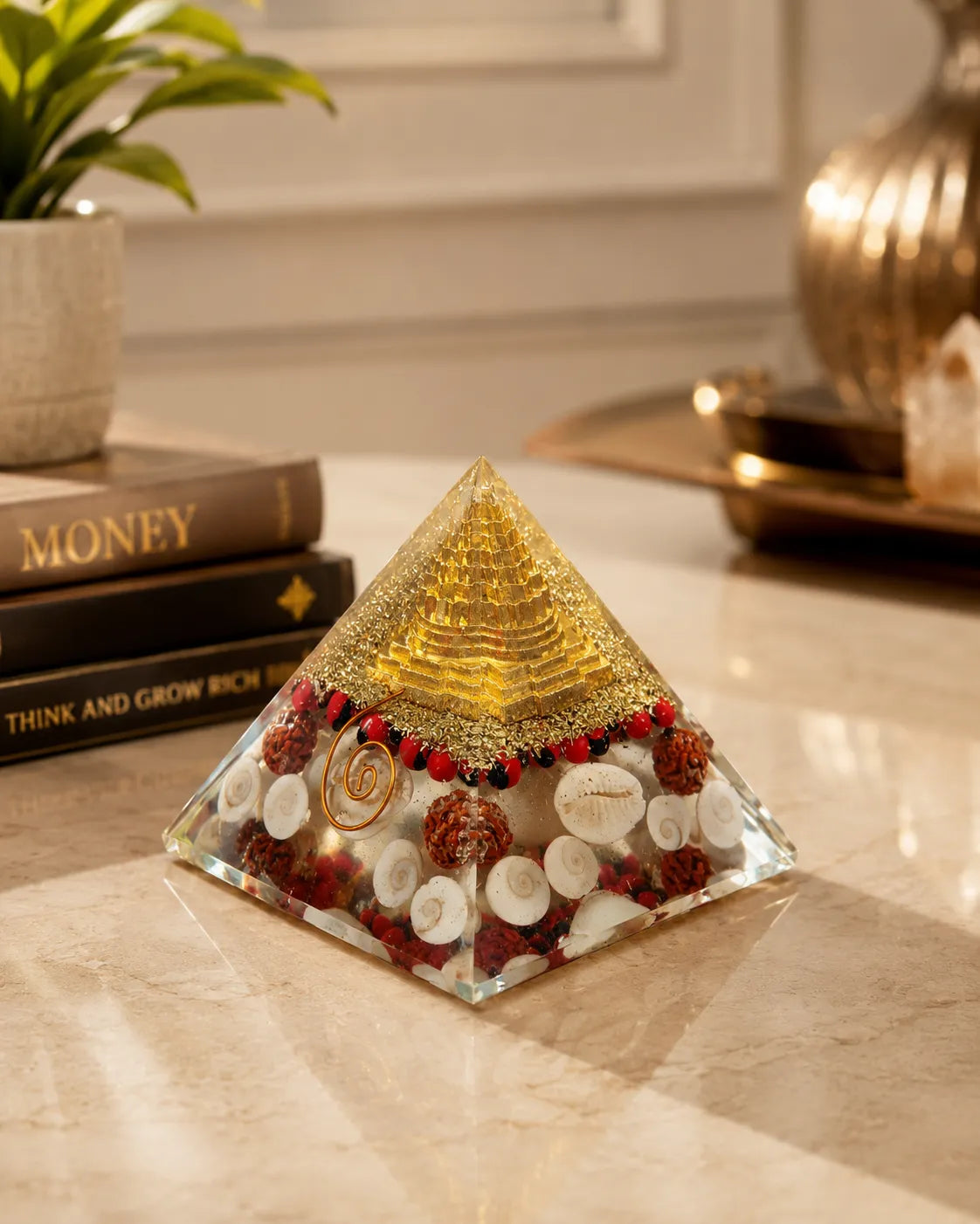 Closeup of Gomti Chakras, rudraksha and gold in Laxmi Orgone Pyramid