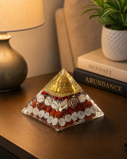 Closeup of gold top, rudraksha and cowrie shells in Laxmi Pyramid